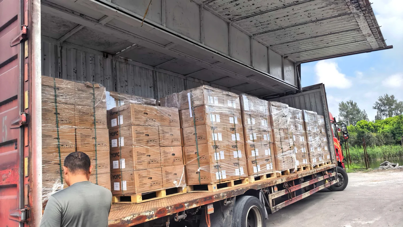 Actual reference photo of palletized cartons in a delivery truck